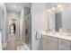 Well-lit bathroom featuring a shower, single vanity, and an open doorway to a walk-in closet at 2140 Ravencliff Dr, Austell, GA 30168
