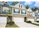 Well-maintained townhome featuring a stone facade, two-car garage, and welcoming curb appeal at 2140 Ravencliff Dr, Austell, GA 30168