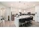 Bright open concept kitchen boasts stainless appliances, modern pendant lighting, and island with seating at 2140 Ravencliff Dr, Austell, GA 30168