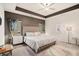 Luxurious main bedroom featuring tray ceilings, neutral tones, and large windows for a bright and airy feel at 2140 Ravencliff Dr, Austell, GA 30168