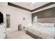 Serene main bedroom with a tray ceiling, plush bedding, and an en-suite bathroom for a luxurious retreat at 2140 Ravencliff Dr, Austell, GA 30168