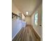 Bright laundry room with wood look floors, white cabinets, countertops and black hardware at 2535 Impala Dr, Cumming, GA 30041