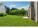 Large backyard with lush green lawn, trees, and a patio offering plenty of space for outdoor activities at 3134 Flery Way, Lawrenceville, GA 30046