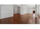 Spacious room with hardwood floors, white columns, and an open layout to dining area at 3134 Flery Way, Lawrenceville, GA 30046