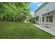 Large backyard featuring a patio, grassy area, and mature trees at 5070 Saddle Bridge Ln, Alpharetta, GA 30022