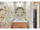 Charming half bath featuring floral wallpaper, vanity and custom mirror at 5070 Saddle Bridge Ln, Alpharetta, GA 30022