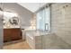 Bright bathroom featuring dual sinks, a soaking tub, and a glass-enclosed shower at 5070 Saddle Bridge Ln, Alpharetta, GA 30022