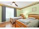 Bright bedroom featuring two twin beds, wood floors, and a ceiling fan at 5070 Saddle Bridge Ln, Alpharetta, GA 30022