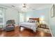 Spacious bedroom with wood floors, a queen bed, and ample natural light at 5070 Saddle Bridge Ln, Alpharetta, GA 30022