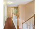 Hallway landing with hardwood floors and white railing at 5070 Saddle Bridge Ln, Alpharetta, GA 30022