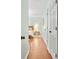 Hallway with wood floors and several white doors at 5070 Saddle Bridge Ln, Alpharetta, GA 30022