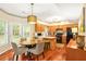 Eat-in kitchen features a pendant light, stainless appliances, and hardwood flooring at 5070 Saddle Bridge Ln, Alpharetta, GA 30022