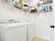 Efficient laundry room with shelving for storage and modern washer and dryer at 5070 Saddle Bridge Ln, Alpharetta, GA 30022