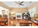 Cozy living room with a fireplace, hardwood floors, ceiling fan and a television for relaxing evenings at 5070 Saddle Bridge Ln, Alpharetta, GA 30022