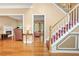Bright and open living room with hardwood floors, a fireplace, and views into other living spaces at 5070 Saddle Bridge Ln, Alpharetta, GA 30022
