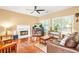Inviting living space with hardwood floors, a fireplace, ample seating, and natural light from large windows at 5070 Saddle Bridge Ln, Alpharetta, GA 30022