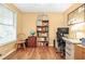 Home office featuring a desk, shelving, and laminate wood floors at 5070 Saddle Bridge Ln, Alpharetta, GA 30022