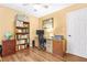 Well-lit home office with desk, shelving, and neutral color scheme at 5070 Saddle Bridge Ln, Alpharetta, GA 30022