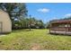 Lush backyard features a separate storage building and porch with a wooden railing at 578 Laney Rd, Locust Grove, GA 30248