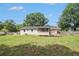 The backyard features a lush lawn and mature trees with access to a screened porch at 578 Laney Rd, Locust Grove, GA 30248