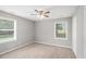 Bright bedroom features neutral walls, carpet flooring, ceiling fan and natural lighting from the windows at 578 Laney Rd, Locust Grove, GA 30248