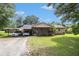 Charming single-story home with a covered front porch, gravel driveway, and lush green lawn at 578 Laney Rd, Locust Grove, GA 30248