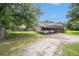Single-story house features an open yard with a long gravel driveway and covered parking at 578 Laney Rd, Locust Grove, GA 30248