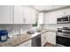 Bright kitchen featuring white cabinets, stainless steel appliances, and granite countertops at 578 Laney Rd, Locust Grove, GA 30248