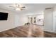 Open living room with hardwood floors, ceiling fan, and sliding glass doors to the deck at 578 Laney Rd, Locust Grove, GA 30248
