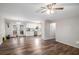 Open-concept living room with laminate floors, ceiling fan, and neutral paint colors at 578 Laney Rd, Locust Grove, GA 30248