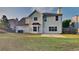 View of the home's rear exterior featuring a well-maintained lawn and an open patio at 6170 Winston Trce, Mcdonough, GA 30252