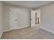 Comfortable bedroom with neutral carpet, a window, and an open doorway to the staircase at 6170 Winston Trce, Mcdonough, GA 30252