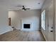 Living room with hardwood floors, fireplace, ceiling fan and stairway at 6170 Winston Trce, Mcdonough, GA 30252