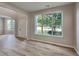Open floor plan with hardwood floors, archway and a large window at 6170 Winston Trce, Mcdonough, GA 30252