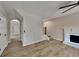 Open living room with wood-look floors, a fireplace, and a view to the staircase at 6170 Winston Trce, Mcdonough, GA 30252