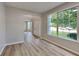 Open floor plan with hardwood floors, archway and a large window at 6170 Winston Trce, Mcdonough, GA 30252