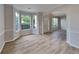 Open-concept living room with hardwood floors, large windows, and neutral paint at 6170 Winston Trce, Mcdonough, GA 30252
