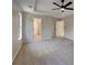 Spacious main bedroom featuring plush carpet, tray ceiling with fan, and multiple closets for ample storage at 6170 Winston Trce, Mcdonough, GA 30252