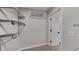 Spacious walk-in closet with metal shelving and rods for organized storage solutions and convenience at 6170 Winston Trce, Mcdonough, GA 30252