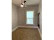 Bright bedroom with neutral carpeting, ceiling fan, and window with blinds at 1234 Triple Hill Dr, Macon, GA 30084