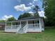 Charming home featuring a welcoming front porch and landscaped yard at 1234 Triple Hill Dr, Macon, GA 30084