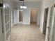 Neutral hallway with tile floors, chandelier lighting, and access to various rooms at 1234 Triple Hill Dr, Macon, GA 30084