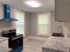 Modern kitchen featuring stainless steel appliances, granite countertops, and tile floors at 1234 Triple Hill Dr, Macon, GA 30084