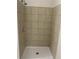 Walk-in shower featuring light beige tile and sleek fixtures at 1234 Triple Hill Dr, Macon, GA 30084