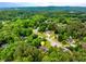 Expansive aerial view of a home nestled among lush greenery in a serene, wooded community at 3982 Ivory Gables Pl, Buford, GA 30519