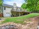Spacious backyard with large deck offers outdoor living with lush greenery and mature trees at 3982 Ivory Gables Pl, Buford, GA 30519