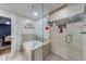 Bright bathroom featuring separate soaking tub and glass shower, with tile surround at 3982 Ivory Gables Pl, Buford, GA 30519