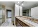 Primary bathroom featuring double sinks, a granite countertop, and walk-in glass shower at 3982 Ivory Gables Pl, Buford, GA 30519