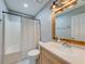 Bathroom featuring a single sink vanity, modern lighting, and a shower-tub combination at 3982 Ivory Gables Pl, Buford, GA 30519