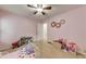 Comfortable bedroom with plush carpeting, natural light, and space for creative play at 3982 Ivory Gables Pl, Buford, GA 30519